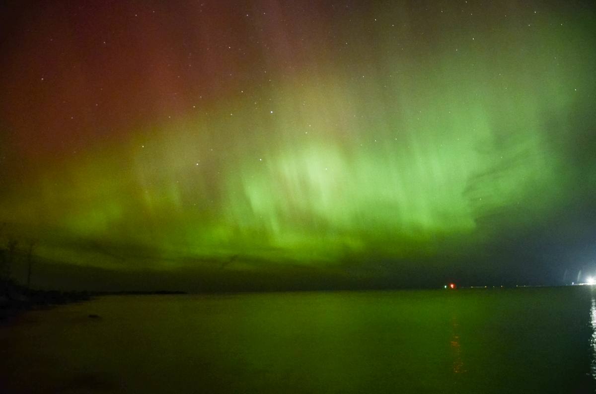 Green curtains with red tops over water · MadSara Images